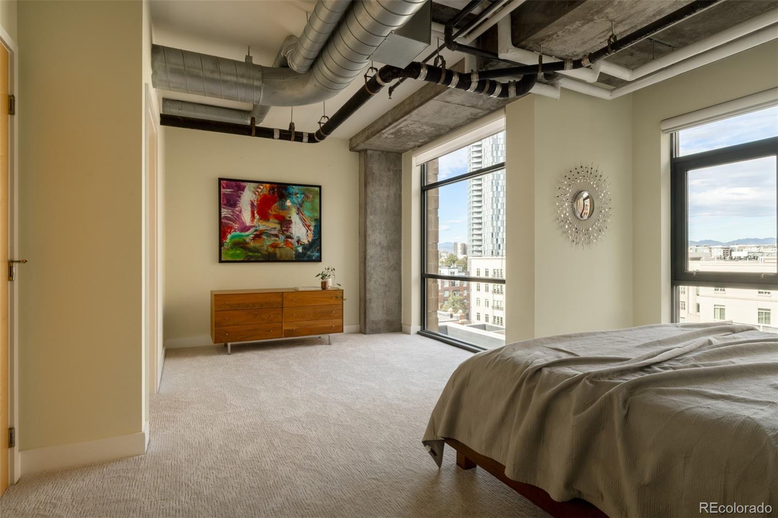 2100 16th St Mall, Unit 607 Denver, CO 80202 - Photo 29 of 46 a bedroom with a bed and a window