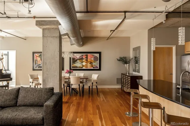 a dining room with furniture and wooden floor