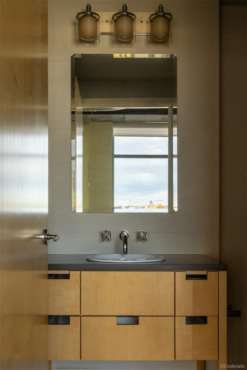 2100 16th St Mall, Unit 607 Denver, CO 80202 - Photo 34 of 46 a bathroom with a sink and a mirror