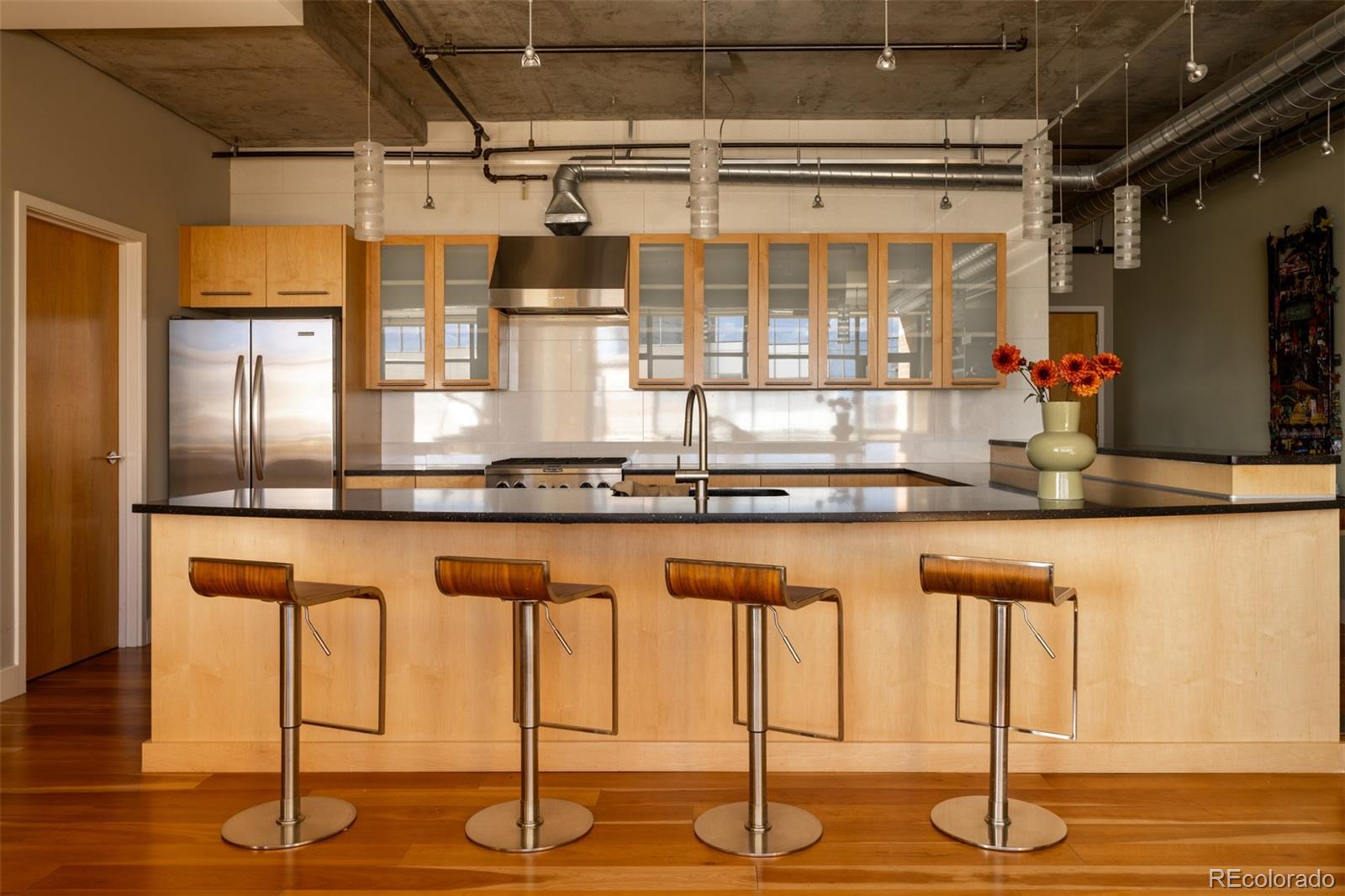 2100 16th St Mall, Unit 607 Denver, CO 80202 - Photo 4 of 46 a kitchen with a sink and a large window