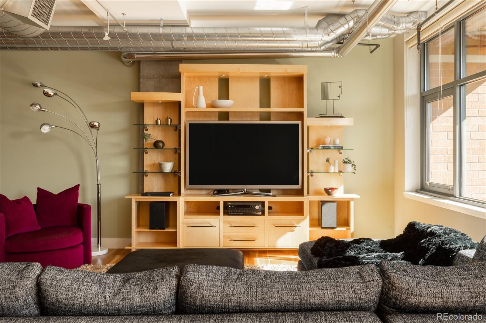 2100 16th St Mall, Unit 607 Denver, CO 80202 - Photo 9 of 46 a living room with furniture and a flat screen tv