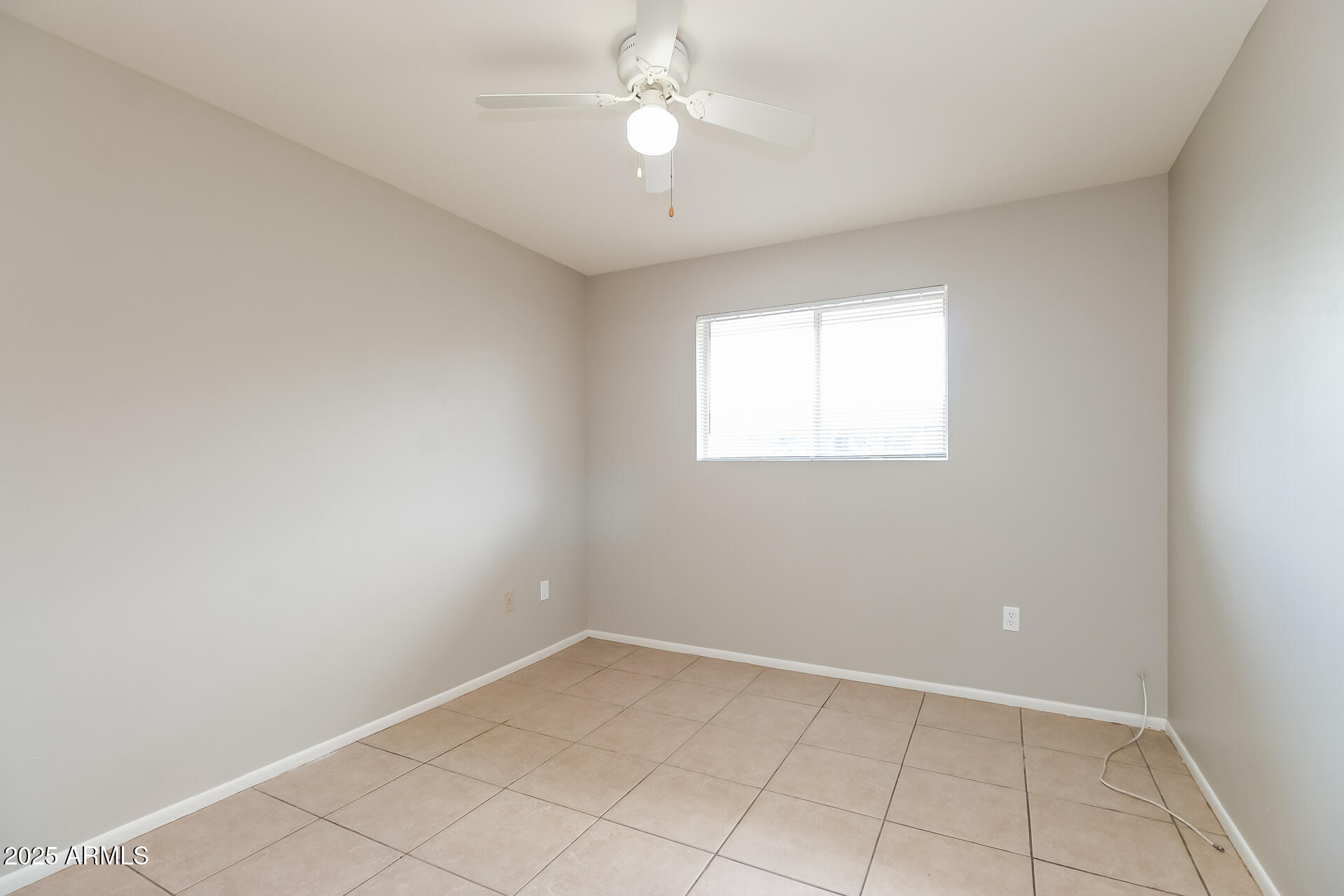 826 East 4th Place, Unit B Mesa, AZ 85203 - Photo 7 of 11 an empty room with a window and a fan