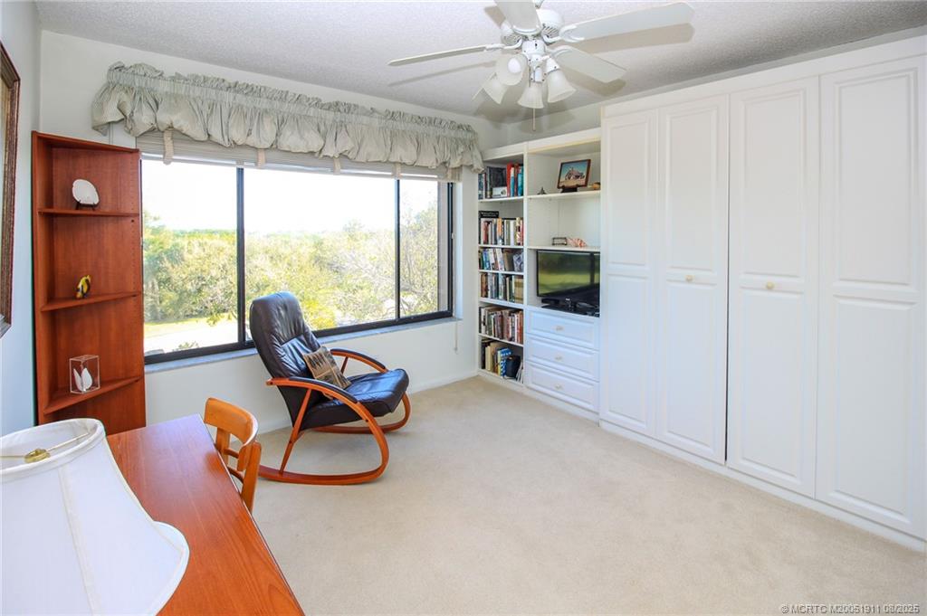 4540 Northeast Sandpebble Trace, Unit 406 Stuart, FL 34996 - Photo 19 of 36 a view of a workspace with furniture and a window