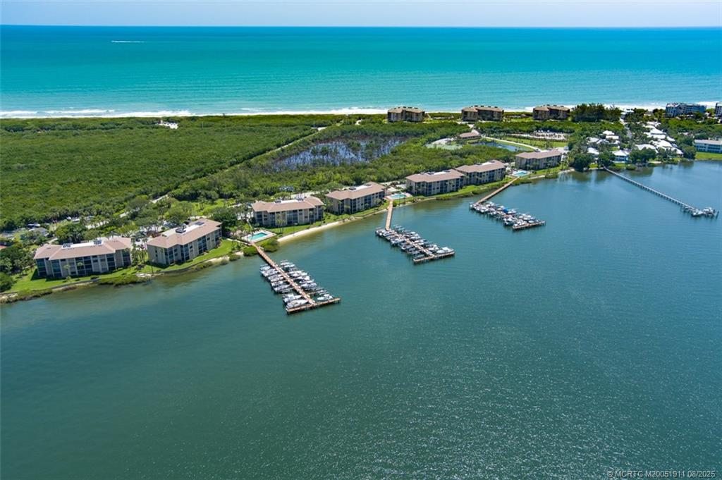 4540 Northeast Sandpebble Trace, Unit 406 Stuart, FL 34996 - Photo 2 of 36 a view of a lake with houses