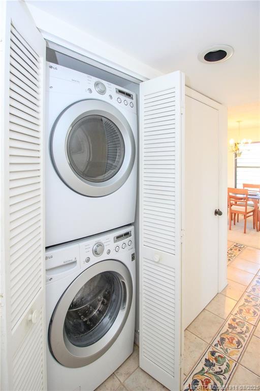 4540 Northeast Sandpebble Trace, Unit 406 Stuart, FL 34996 - Photo 23 of 36 a utility room with dryer and washer
