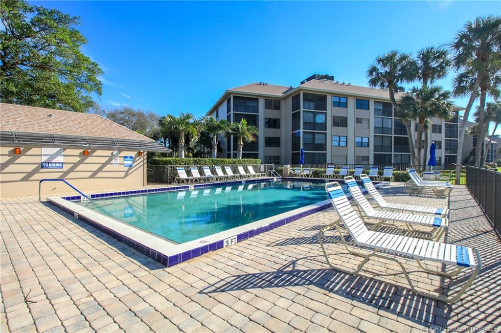4540 Northeast Sandpebble Trace, Unit 406 Stuart, FL 34996 - Photo 25 of 36 a view of a patio with a table and chairs