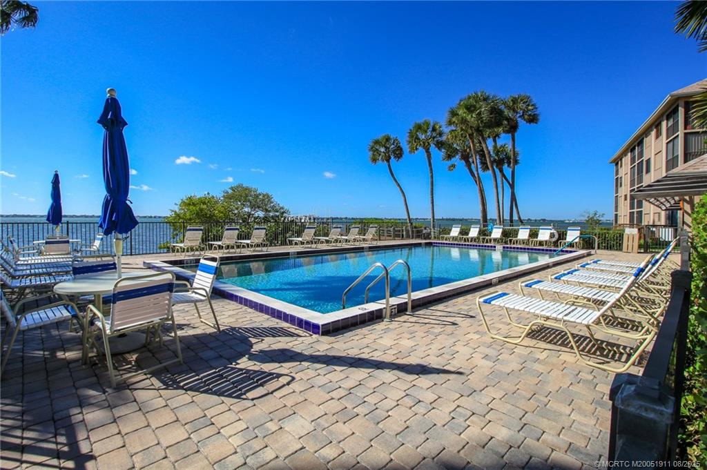 4540 Northeast Sandpebble Trace, Unit 406 Stuart, FL 34996 - Photo 26 of 36 a view of swimming pool with chairs