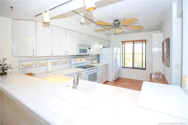 a spacious bathroom with a tub sink and mirror