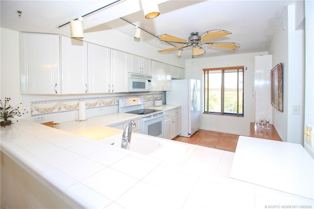 4540 Northeast Sandpebble Trace, Unit 406 Stuart, FL 34996 - Photo 7 of 36 a spacious bathroom with a tub sink and mirror