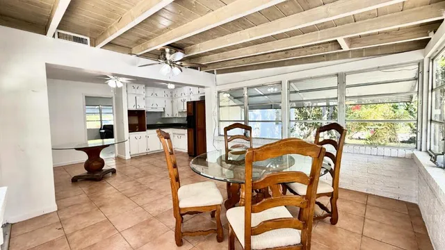 a dining room with furniture and a window