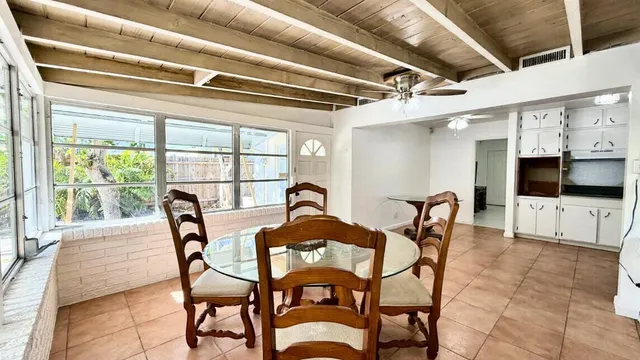 a view of a dining room with furniture and a floor to ceiling window
