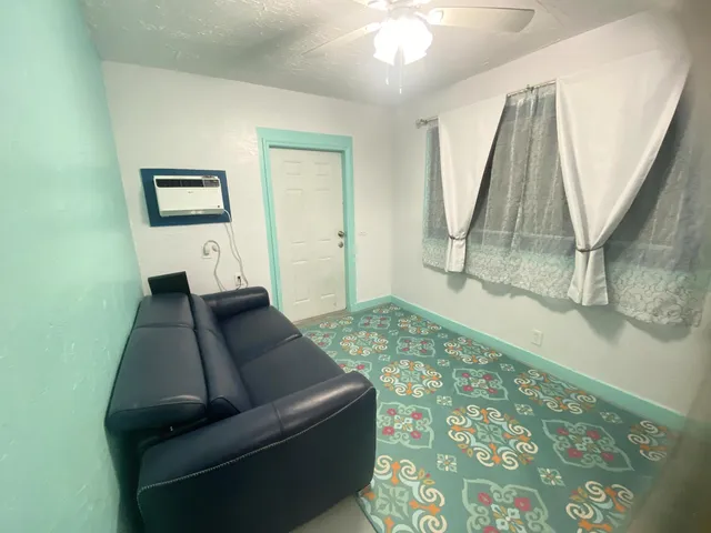 a living room with a couch and a dining table
