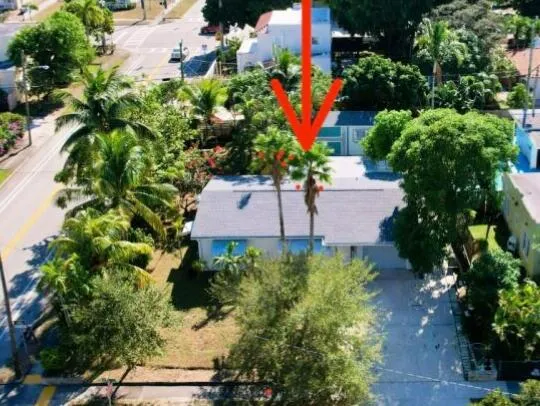 an aerial view of a house with a yard and garden