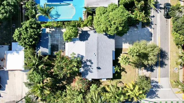 an aerial view of a house with a yard and garden