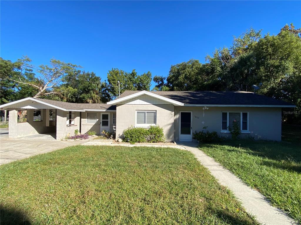 16131 Wallace Street Umatilla, FL 32784 - Photo 1 of 15 a front view of a house with a garden