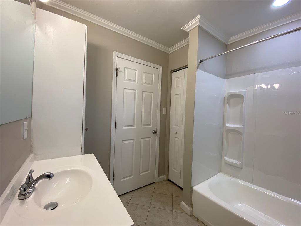 16131 Wallace Street Umatilla, FL 32784 - Photo 12 of 15 a bathroom with a sink and a tub