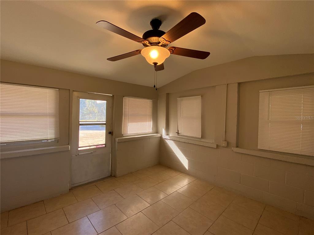 16131 Wallace Street Umatilla, FL 32784 - Photo 14 of 15 a view of an empty room with window and chandelier fan