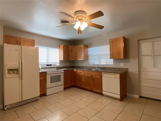 a kitchen with granite countertop cabinets and appliances