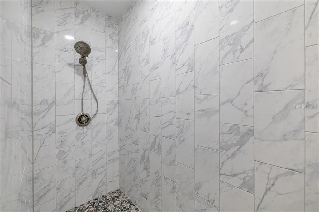 5056 Oak Leaf Lane Hernando Beach, FL 34607 - Photo 16 of 34 a bathroom with a shower