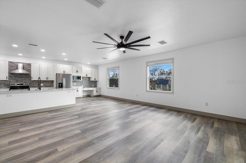 5056 Oak Leaf Lane Hernando Beach, FL 34607 - Photo 9 of 34 a view of an kitchen with furniture and a ceiling fan
