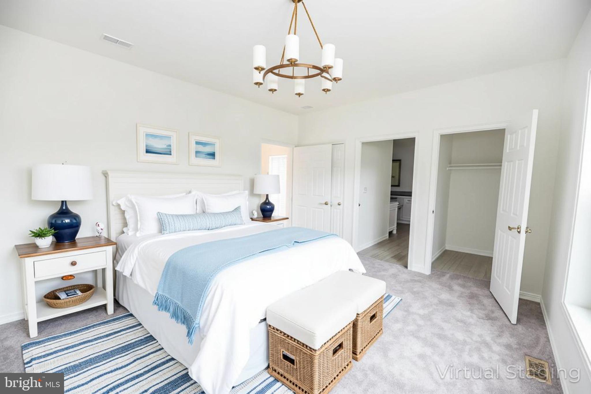 26363 West Pintail Road, Unit 78 Millsboro, DE 19966 - Photo 11 of 40 a spacious bedroom with a bed and a chandelier