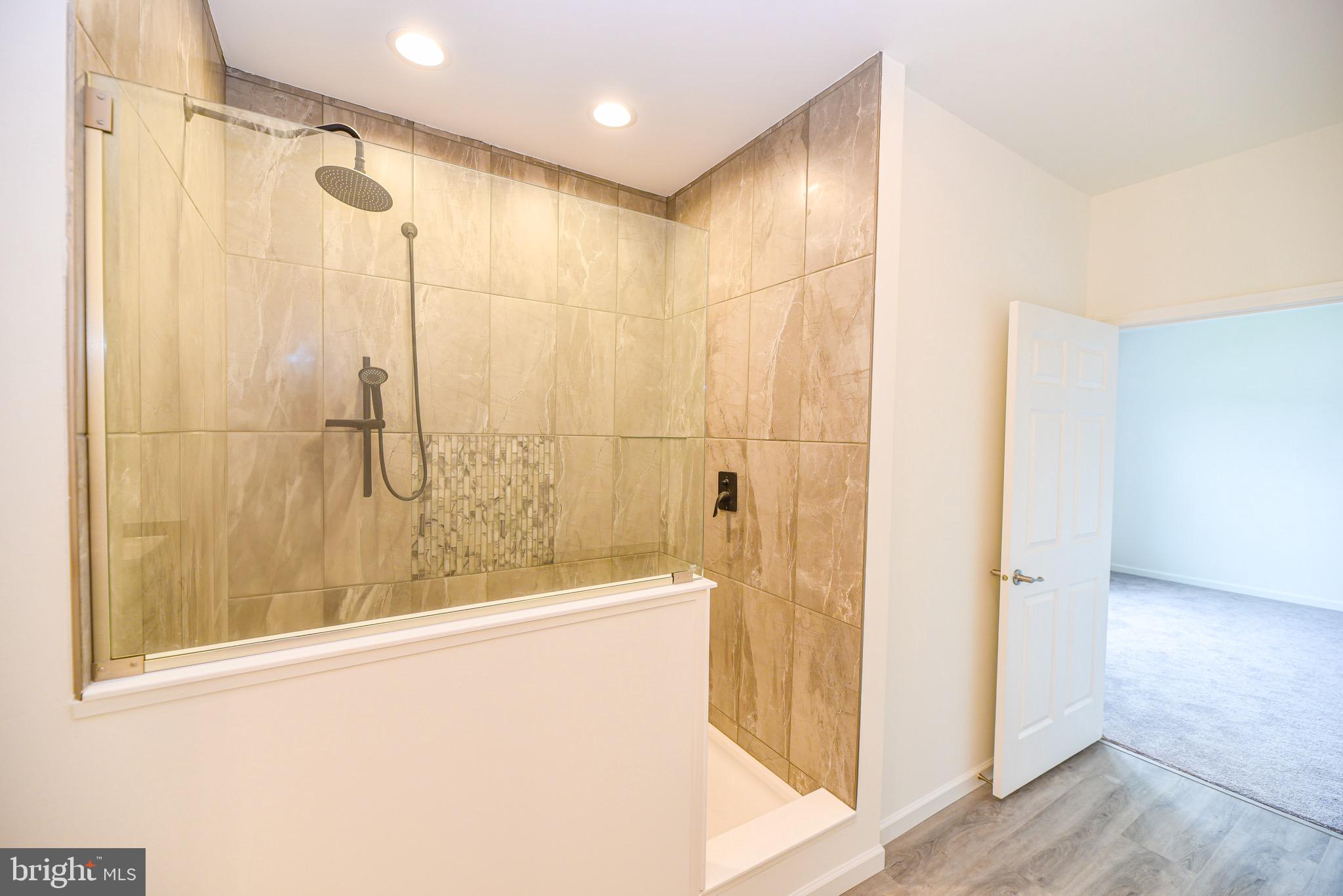 26363 West Pintail Road, Unit 78 Millsboro, DE 19966 - Photo 14 of 40 a bathroom with a shower and a tub