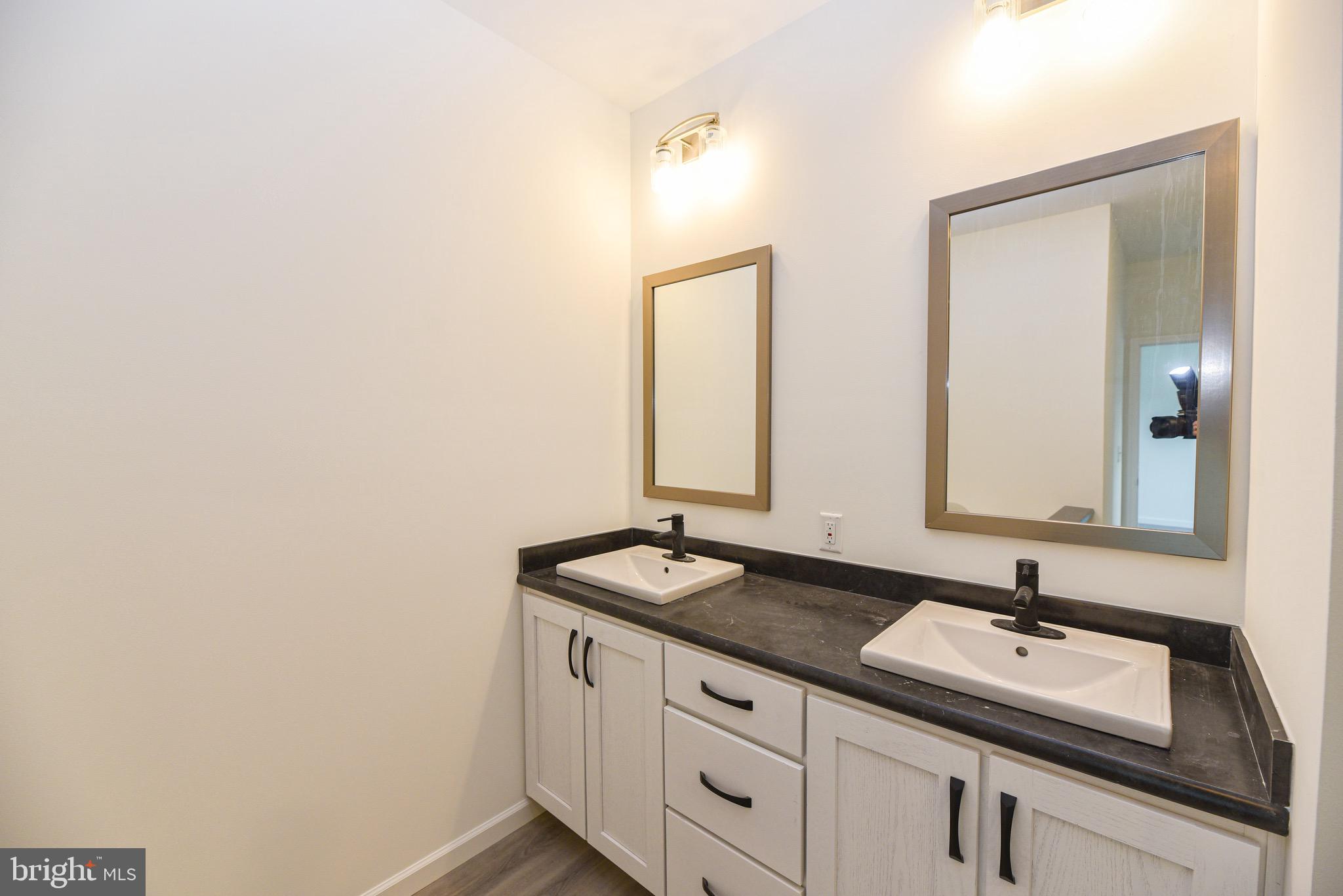 26363 West Pintail Road, Unit 78 Millsboro, DE 19966 - Photo 16 of 40 a bathroom with a sink and a mirror