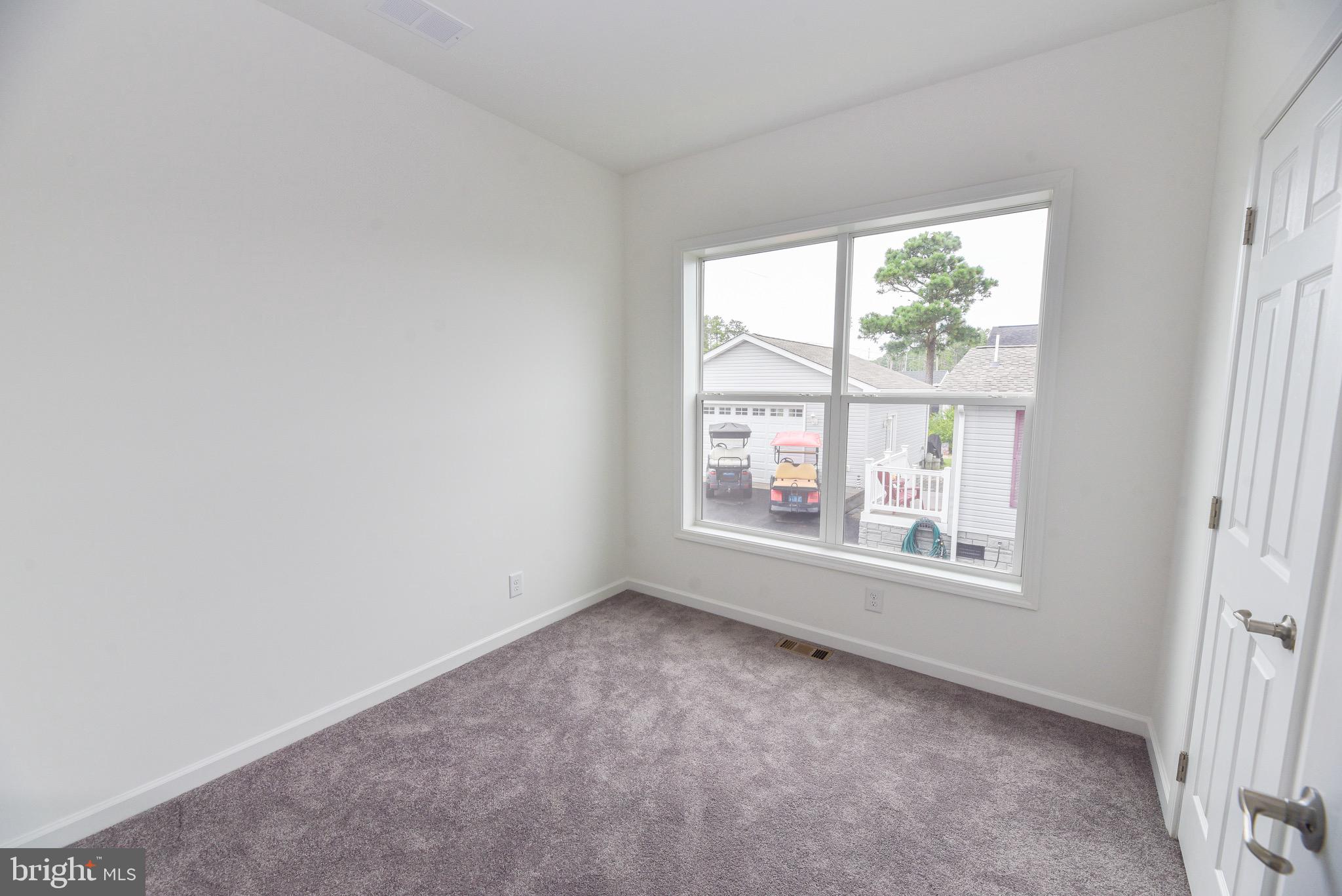 26363 West Pintail Road, Unit 78 Millsboro, DE 19966 - Photo 17 of 40 an empty room with a window