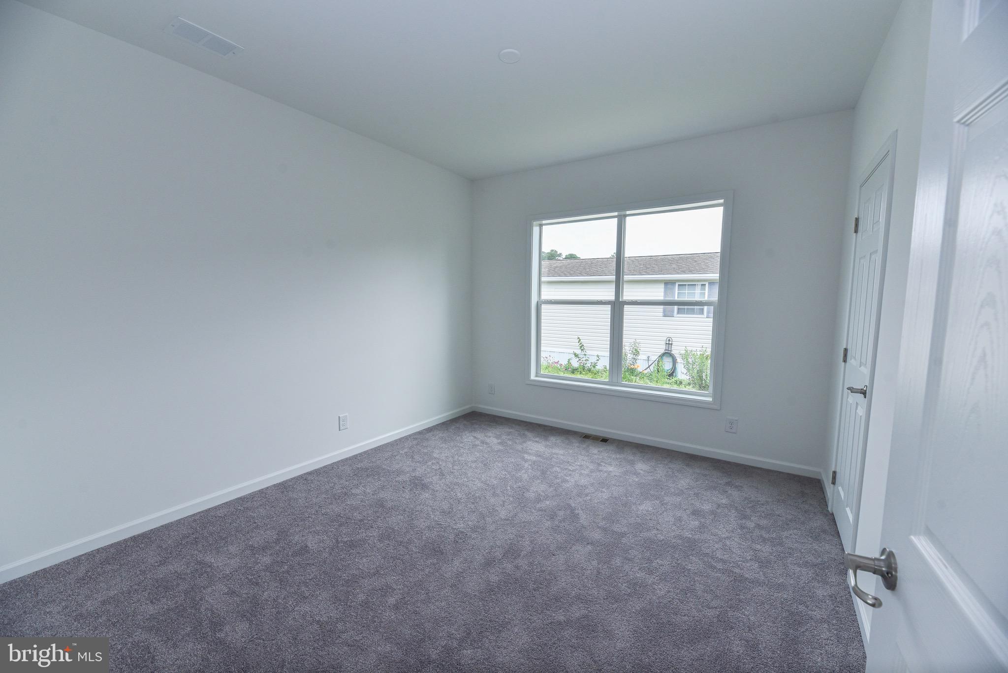 26363 West Pintail Road, Unit 78 Millsboro, DE 19966 - Photo 20 of 40 an empty room with windows