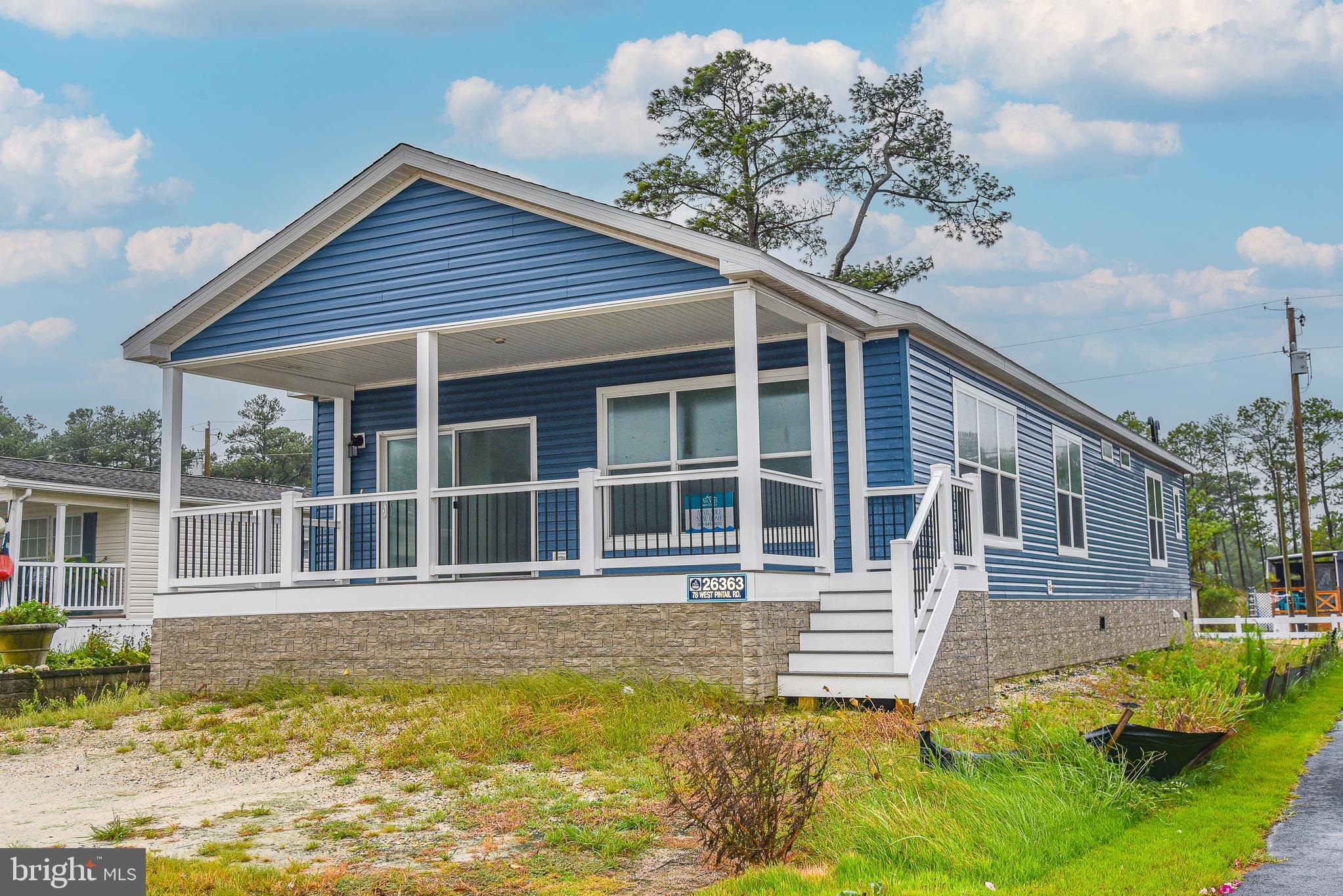 26363 West Pintail Road, Unit 78 Millsboro, DE 19966 - Photo 2 of 40 a house that has a large pool in front of it