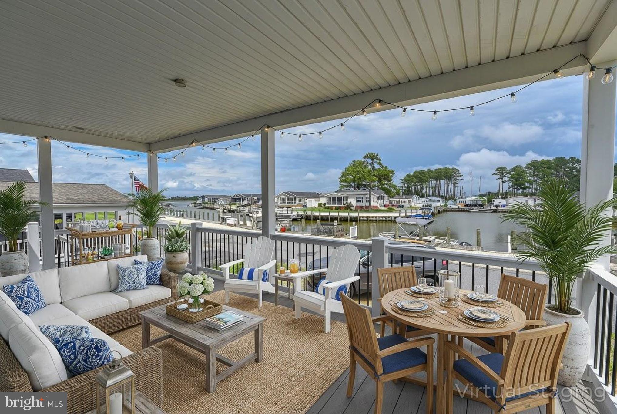 26363 West Pintail Road, Unit 78 Millsboro, DE 19966 - Photo 38 of 40 a balcony with furniture and a potted plant