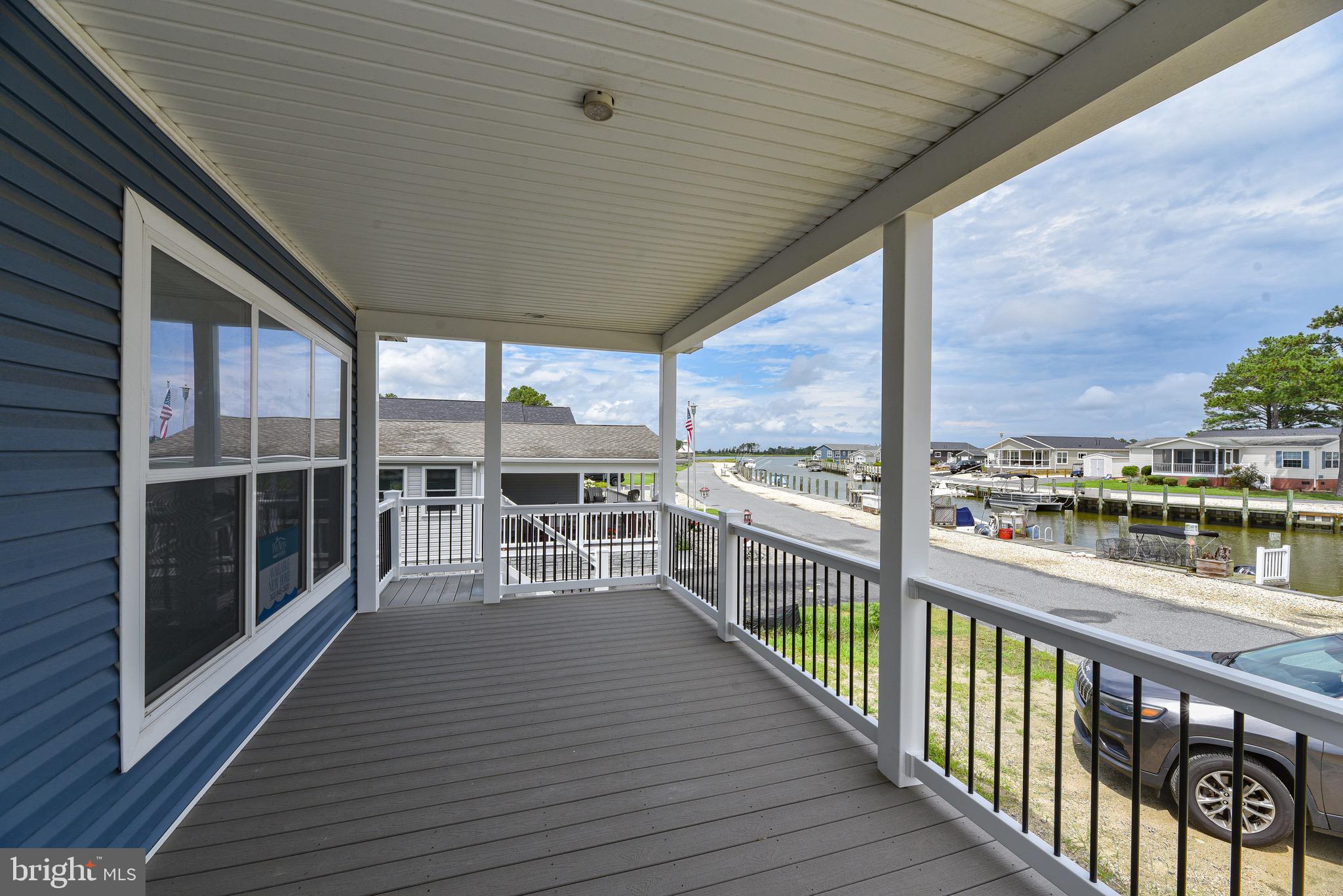 26363 West Pintail Road, Unit 78 Millsboro, DE 19966 - Photo 39 of 40 a view of a balcony with wooden floor