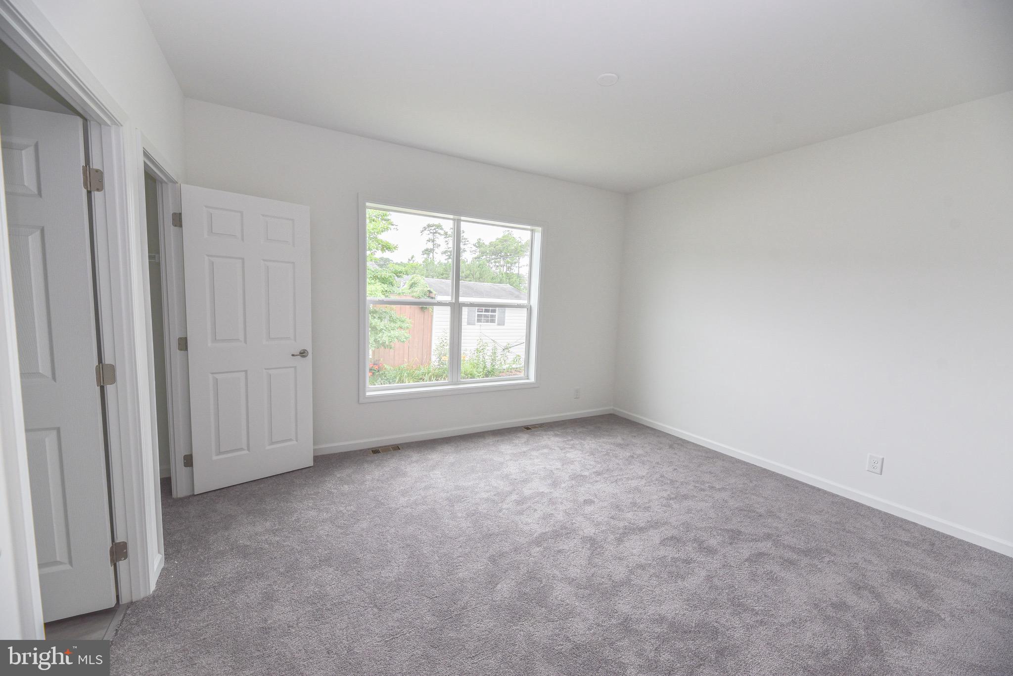 26363 West Pintail Road, Unit 78 Millsboro, DE 19966 - Photo 8 of 40 an empty room with windows