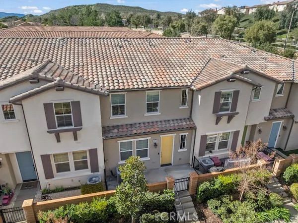 a view of a house with more windows and a small yard
