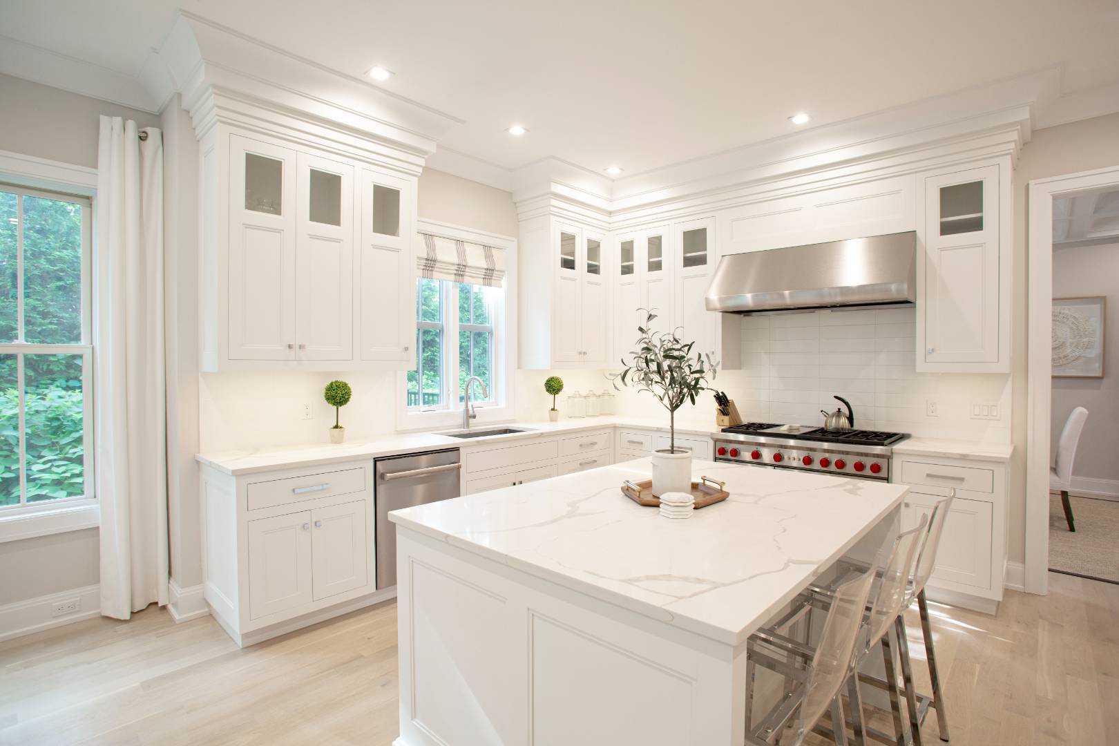 12 Sellentin Way Bridgehampton, NY 11932 - Photo 13 of 49 a kitchen with a sink a stove a refrigerator and white cabinets