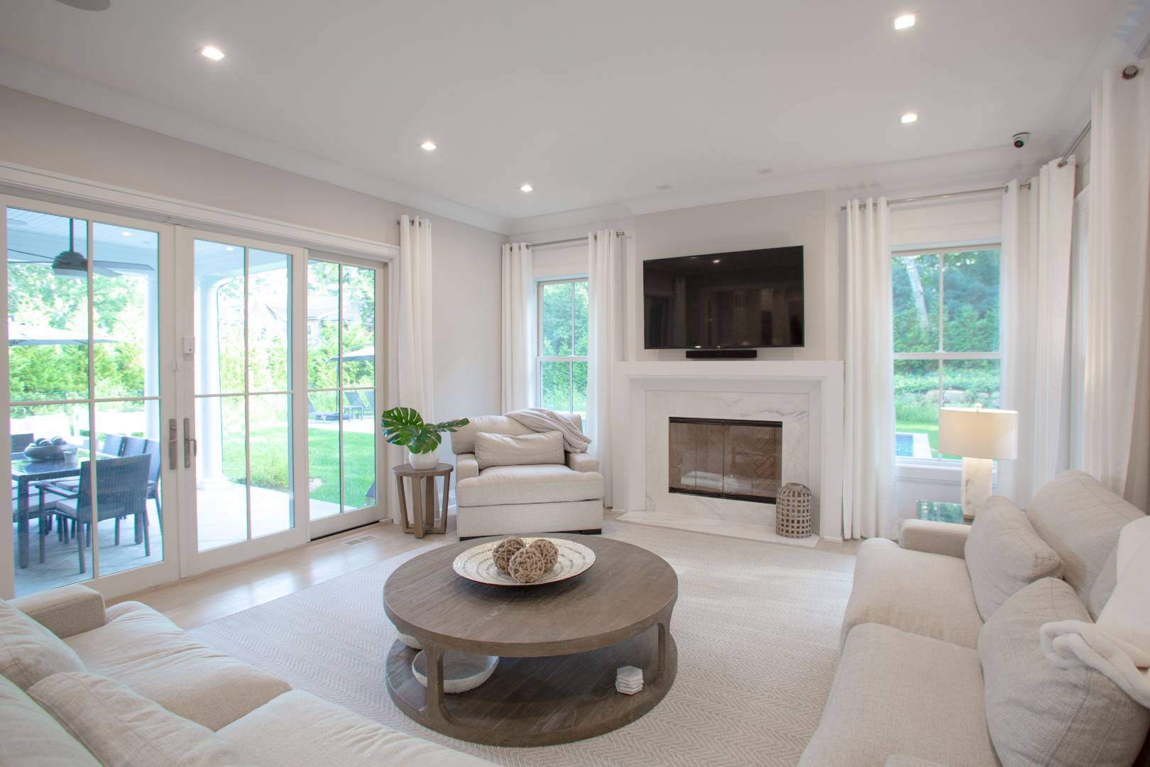 12 Sellentin Way Bridgehampton, NY 11932 - Photo 15 of 49 a living room with furniture a fireplace and a flat screen tv