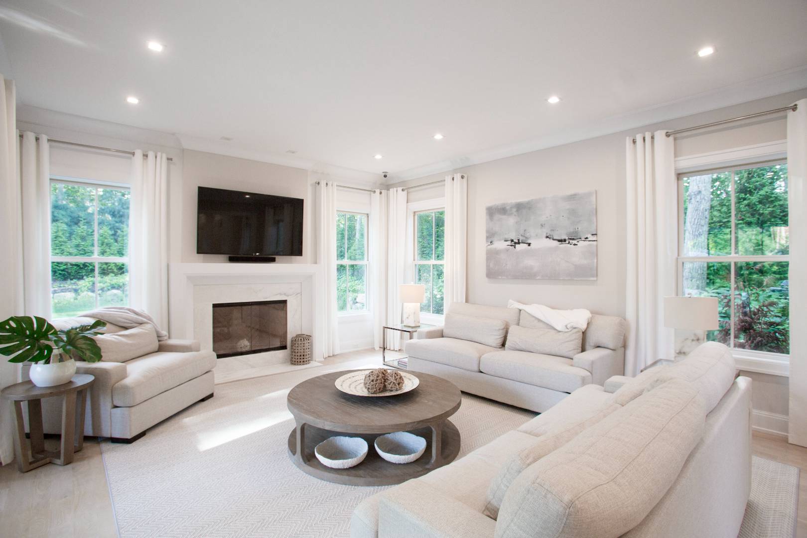 12 Sellentin Way Bridgehampton, NY 11932 - Photo 16 of 49 a living room with furniture a flat screen tv and a fireplace