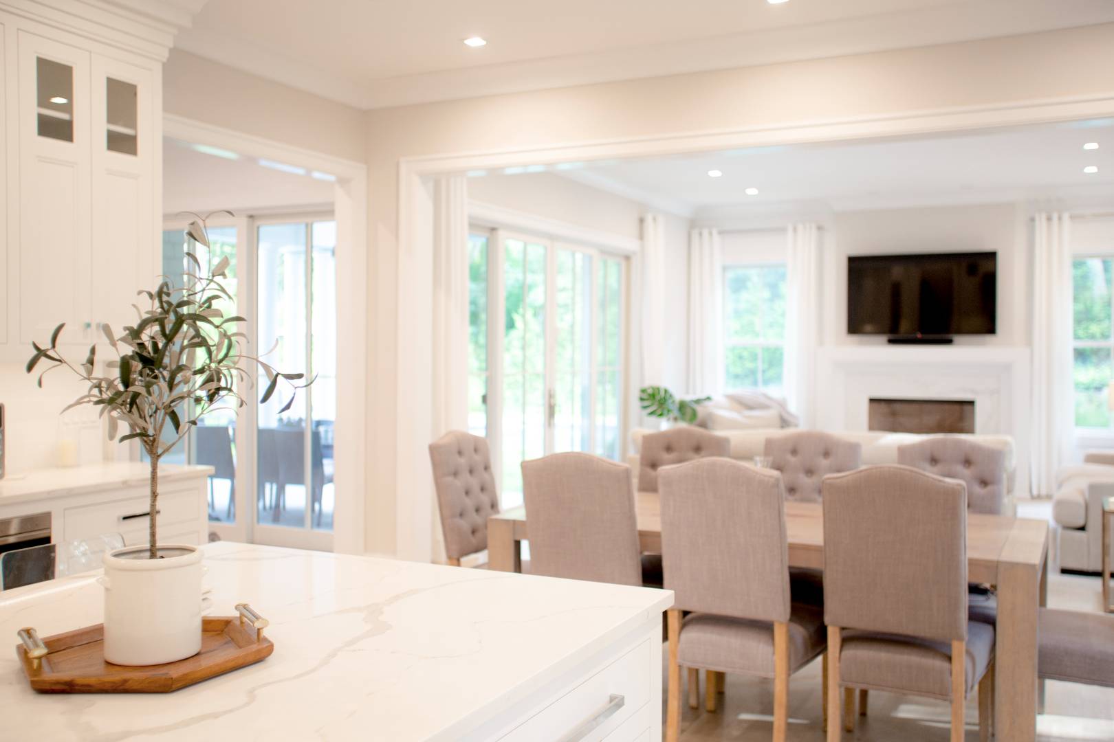 12 Sellentin Way Bridgehampton, NY 11932 - Photo 40 of 49 a living room with fireplace a flat screen tv and a large window