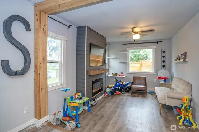 a living room with furniture and a wooden floor