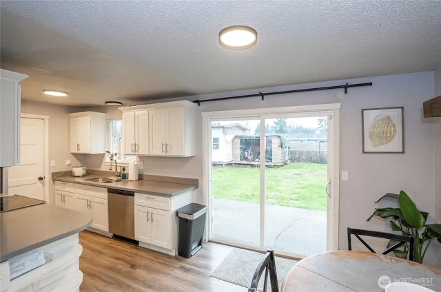 a kitchen with a stove a sink and a refrigerator