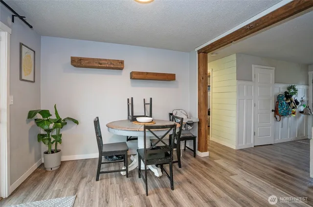 a view of a dining room with furniture and wooden floor
