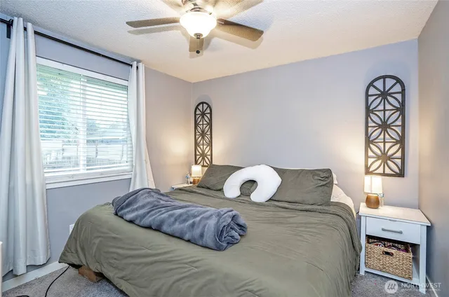 a bedroom with a bed and a window