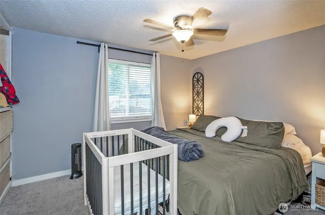 a bedroom with a bed and ceiling fan