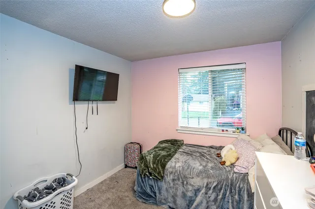 a bed room with a bed window and a television
