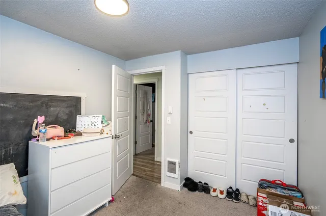 a room with a baby crib and dresser