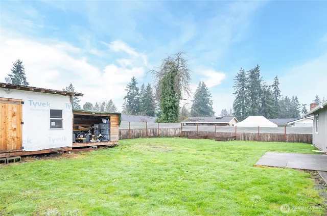 a view of a house with a yard and sitting area
