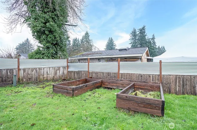a backyard of a house with wooden fence