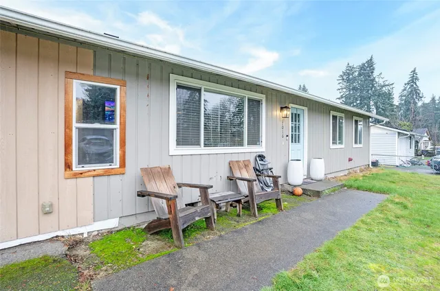 a backyard of a house with table and chairs