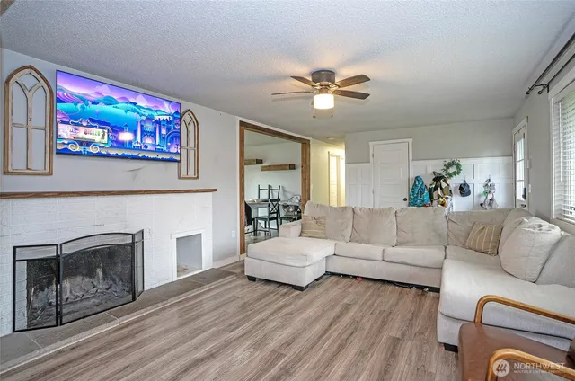 a living room with furniture a fireplace and a flat screen tv