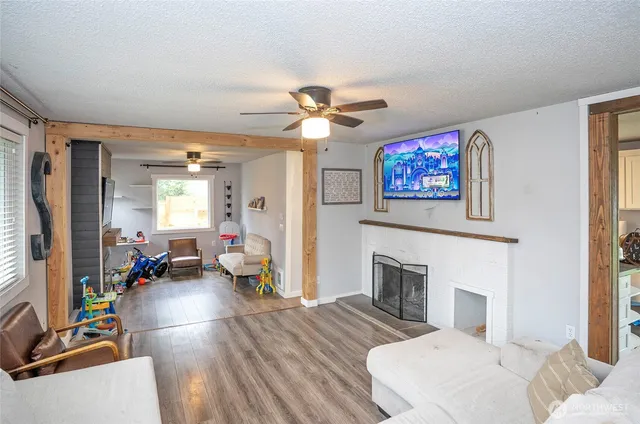 a living room with furniture a fireplace and a flat screen tv